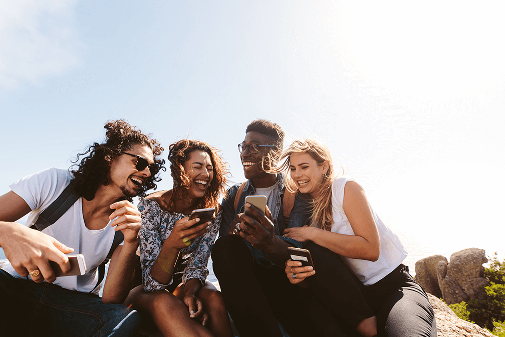 Group of young happy people with mobiles laughing