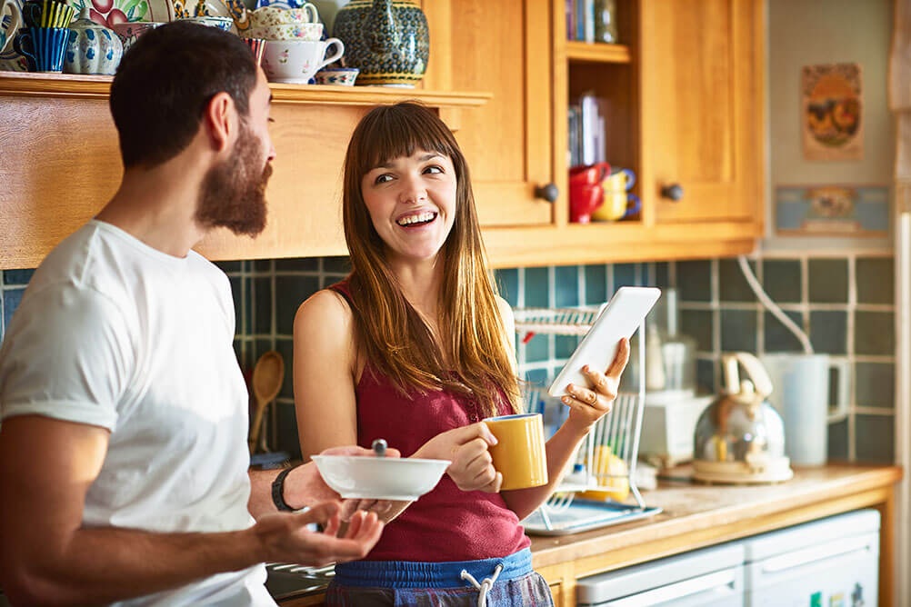 How to play the Irish Lotto online Couple play the Irish Lotto on their tablet over breakfast in their kitchen