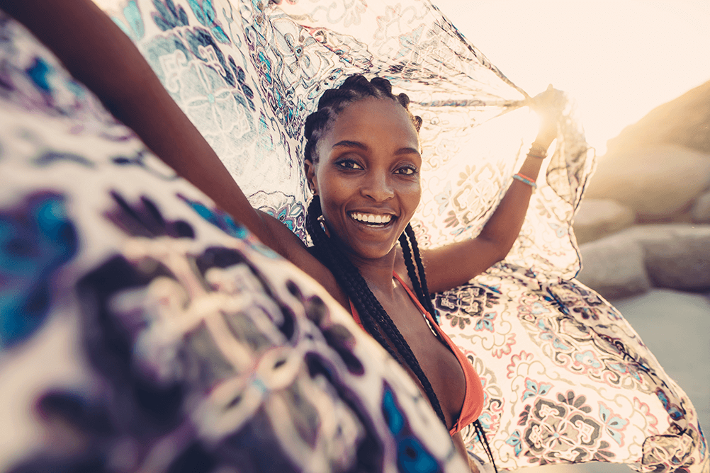 Happy woman holding up a towel