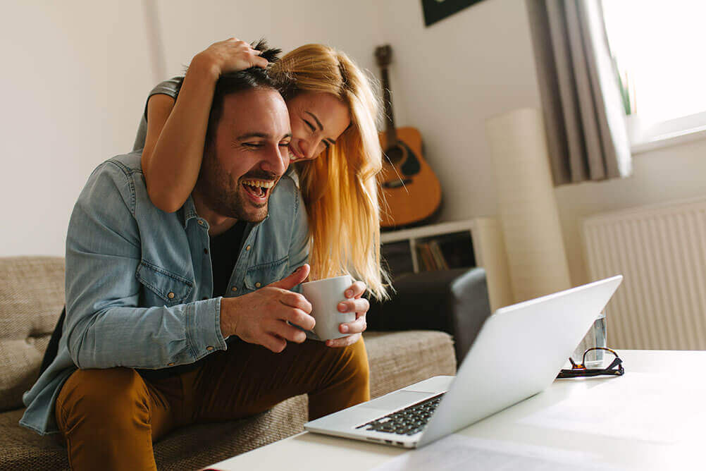 How to stay safe when betting online A couple celebrate as they look at the results of the lottery on their laptop