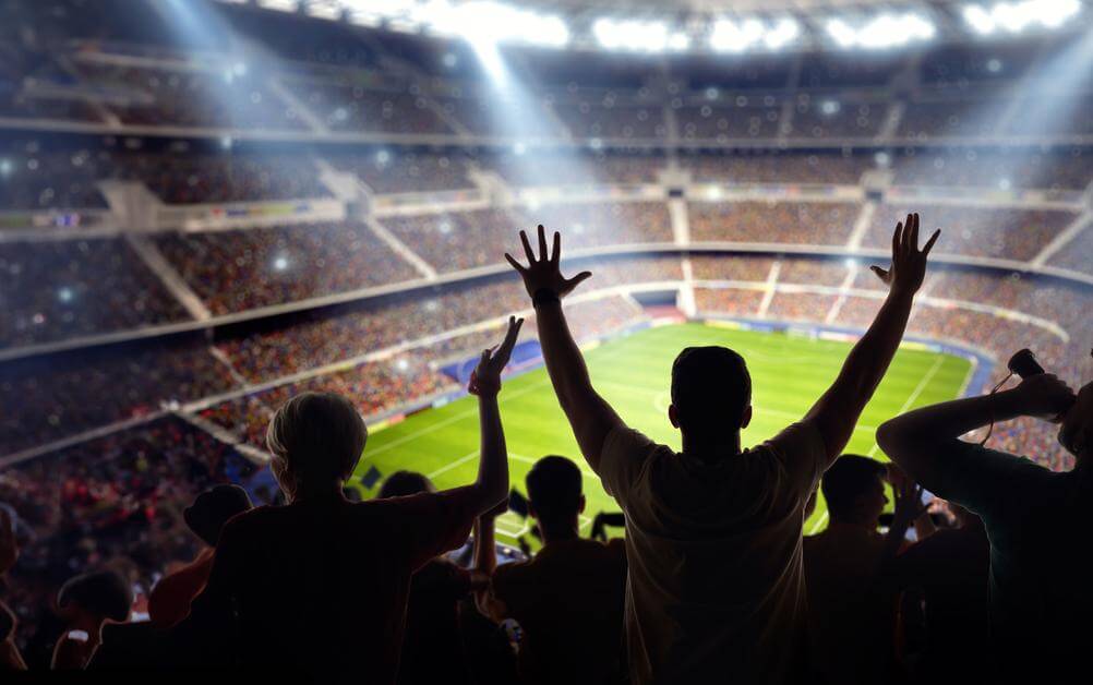 Winning Margin Bets A shot of fans in a stadium, taken from the above the last row of seats. Fans are celebrating as their winning margin bet has landed